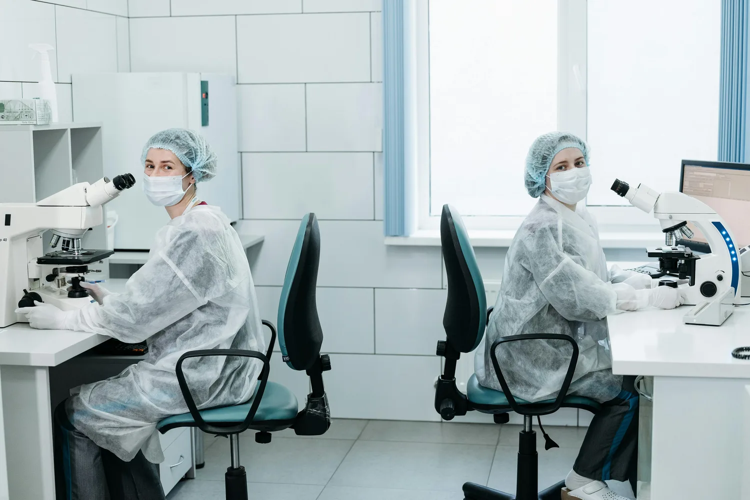Quality-control laboratory technicians at the microscope